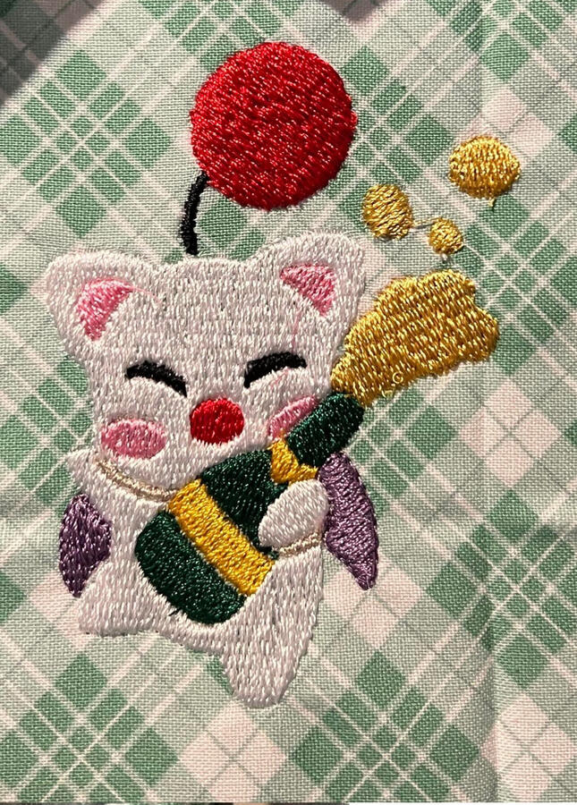 An embroidery test run of a moogle from final fantasy popping a bottle of champagne.